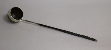 An early 19th century white metal mounted sycamore toddy ladle(a.f.) with baleen handle, 35cm.