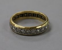 A yellow metal and diamond set full eternity ring, size N.