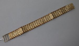 A 1970's 9ct gold bark effect flat link bracelet, approx 18cm.