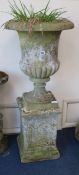 A Grecian style reconstituted stone garden urn, on plinth W.53cm