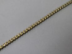 A 14k gold and diamond line bracelet, set with forty seven stones, 19cm.