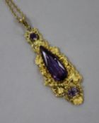 A repousse yellow metal and amethyst set tapering pendant, on a yellow metal chain, pendant 63mm.