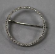 An early to mid 20th century white metal and diamond set circular open brooch, bearing the