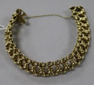 A 14ct gold fancy link bracelet, with safety chain.
