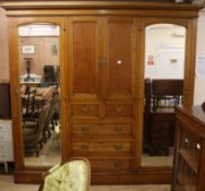 An Edwardian lemon wood triple wardrobe W.244cm