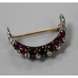 An early 20th century yellow and white metal, diamond and gem set crescent brooch, 30mm.