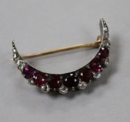 An early 20th century yellow and white metal, diamond and gem set crescent brooch, 30mm.