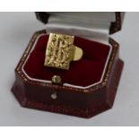 A yellow metal signet ring, the rectangular matrix applied with initials 'A S' (tests as 18ct gold),