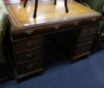 A 1920's yew veneered pedestal desk W.119cm