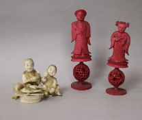 Two carved stained ivory chess pieces and ivory figurative group