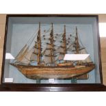 A model ship in a glazed display case height 51 cm width 66cm