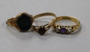 A George V amethyst and diamond three stone ring and two other rings including a bloodstone signet