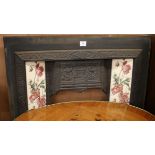 An Edwardian cast iron tiled fire insert W.97cm