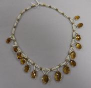 A triple strand seed pearl and graduated facet cut citrine set fringe necklace, with yellow metal