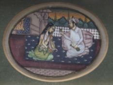 An Indian watercolour on ivory, oval, depicting a couple in an interior, gilt framed, 5 x 6.5cm