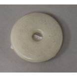 A Chinese white jade bi disc