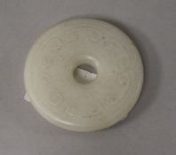 A Chinese white jade bi disc