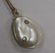 A yellow metal mounted diamond set baroque pearl pendant, on a yellow metal chain, pendant 25mm.