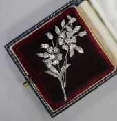 A 1960's 18ct white gold and diamond set floral spray brooch, 51mm.