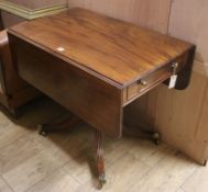 A Regency mahogany drop-flap Pembroke table, fitted drawer and dummy drawer on splayed quadriparte