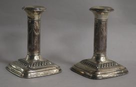 A pair of George V silver candlesticks, E.J. Greenberg, Birmingham, 1921, 11.8cm.