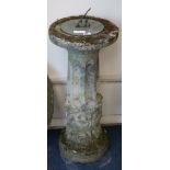 A composition stone pedestal sun dial and a mill stone W.32cm and W.59cm