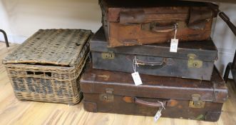 Three vintage leather suitcases and a wicker hamper