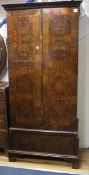 A 1930's walnut wardrobe W.94cm