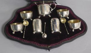 A cased late Victorian silver seven piece condiment set with three matching spoons, London, 1893/4.