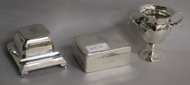 A 1930's silver inkstand, a silver trophy cup and a silver cigarette box.
