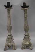 A pair of Renaissance style carved and silvered wood candlesticks, the tapered stems with knop,