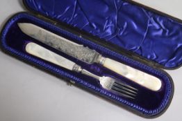 A cased Victorian mother of pearl handled silver serving knife and fork by James Deakins & Sons,