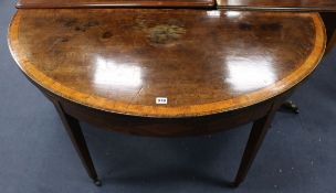 A George III mahogany demi-lune folding dining table W.132cm