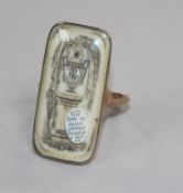 An early 19th century yellow metal and ivory mourning ring, the rectangular panel depicting an urn