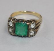 A late 19th/early 20th century yellow metal, emerald and diamond dress ring, size O.