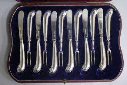 A cased set of six pairs of Edwardian silver pistol handled dessert eaters by James Dixon & Sons,