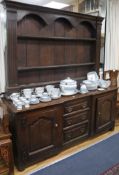 A George III oak dresser with plate rack W.180cm