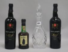 A decanter and three bottles of port