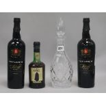 A decanter and three bottles of port