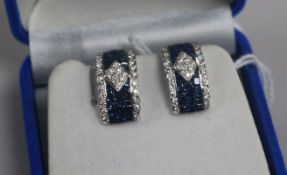 A modern pair of 18ct white gold, sapphire and diamond curved rectangular ear clips, 17mm.