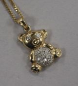 A modern 9ct gold and diamond set teddy bear pendant, on a 9ct gold chain, pendant 18mm.