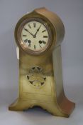 A brass-cased mantel clock in the Art Nouveau taste, having circular Roman dial and lancet-shaped