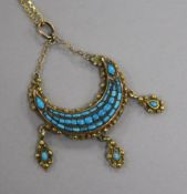 A late 19th century Indian? yellow metal and turquoise set crescent drop pendant, on a gilt metal