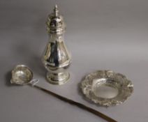 A repousse white metal toddy ladle with baleen handle, a large silver sugar caster and a repousse