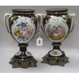 A pair of 19th century French porcelain urns, metal-mounted, heightened in gilt on a cobalt blue