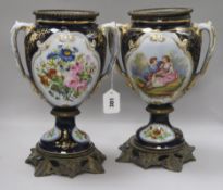 A pair of 19th century French porcelain urns, metal-mounted, heightened in gilt on a cobalt blue