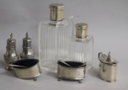 Two French silver-mounted glass toilet bottles, a silver three-piece condiment set and a pair of
