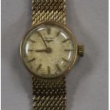 A lady's 9ct gold Longines manual wind wrist watch, on a 9ct gold Longines bracelet, with Longines