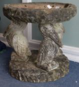 A reconstituted stone bird bath with pelican supports W.57cm