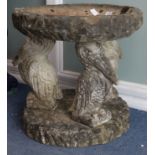 A reconstituted stone bird bath with pelican supports W.57cm